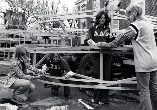 Students building the frame of a parade float.