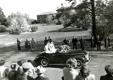 1945 Homecoming queen and attendants riding in a car in the homecoming parade. 